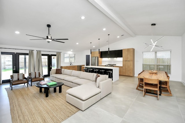 living room with sink, vaulted ceiling with beams, and french doors