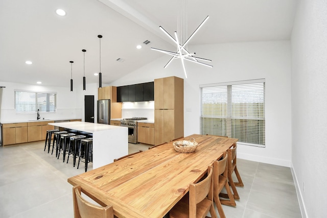 tiled dining room featuring an inviting chandelier, sink, and high vaulted ceiling