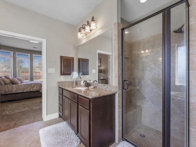 bathroom featuring vanity, tile patterned flooring, and a shower with shower door