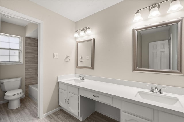 full bathroom featuring vanity, toilet, hardwood / wood-style floors, and shower / bathing tub combination