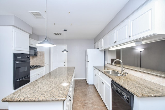 7018 Drowsy Pine Dr, Houston, TX 77092 - kitchen featuring pendant lighting, sink, white cabinetry, black appliances, and light stone countertops
