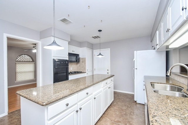 7018 Drowsy Pine Dr, Houston, TX 77092 - kitchen featuring black appliances, decorative light fixtures, sink, and white cabinets
