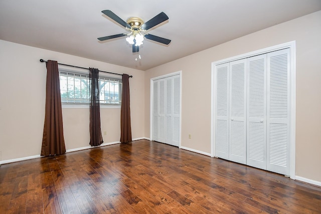7018 Drowsy Pine Dr, Houston, TX 77092 - unfurnished bedroom with multiple closets, ceiling fan, and dark hardwood / wood-style flooring