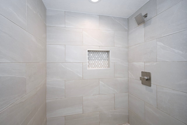 bathroom with tiled shower