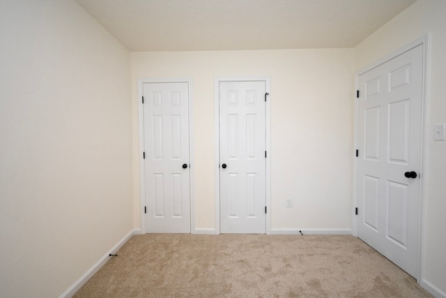 unfurnished bedroom with light colored carpet