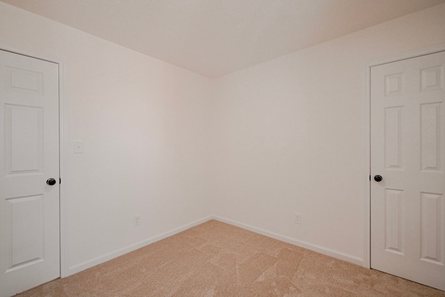 spare room featuring light colored carpet