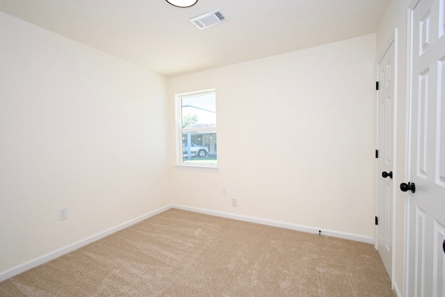 spare room with light colored carpet