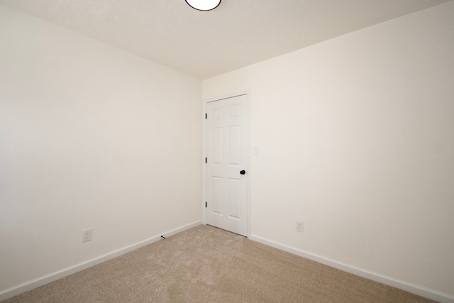 spare room with light colored carpet