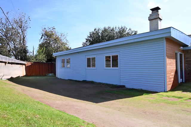 view of property exterior featuring a lawn