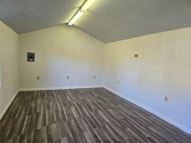 unfurnished room with dark hardwood / wood-style flooring and vaulted ceiling