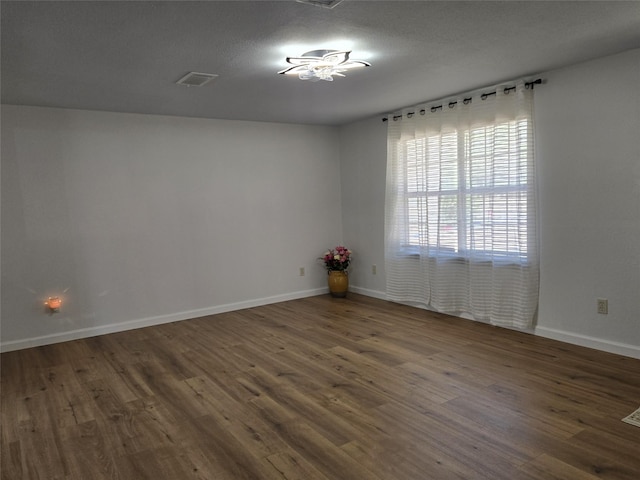 spare room with dark hardwood / wood-style flooring