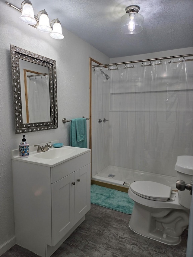 bathroom with hardwood / wood-style floors, curtained shower, a textured ceiling, and toilet