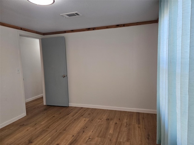 empty room featuring wood-type flooring