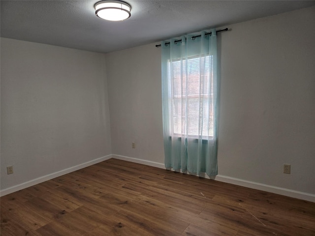 empty room featuring dark hardwood / wood-style flooring