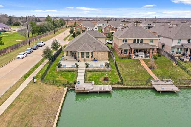 birds eye view of property with a water view and a residential view