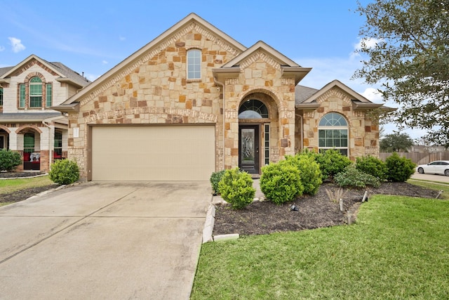 view of front of house featuring a garage, stone siding, concrete driveway, and a front yard