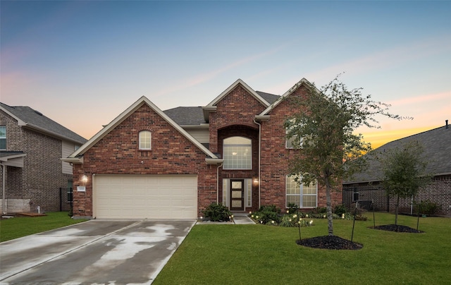 front of property with a lawn and a garage