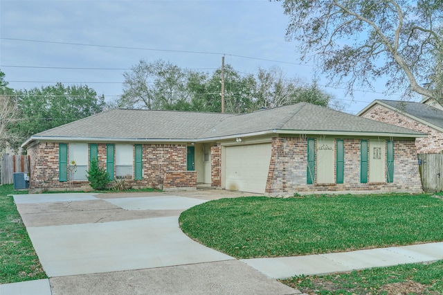 ranch-style home featuring central AC unit, a garage, and a front yard