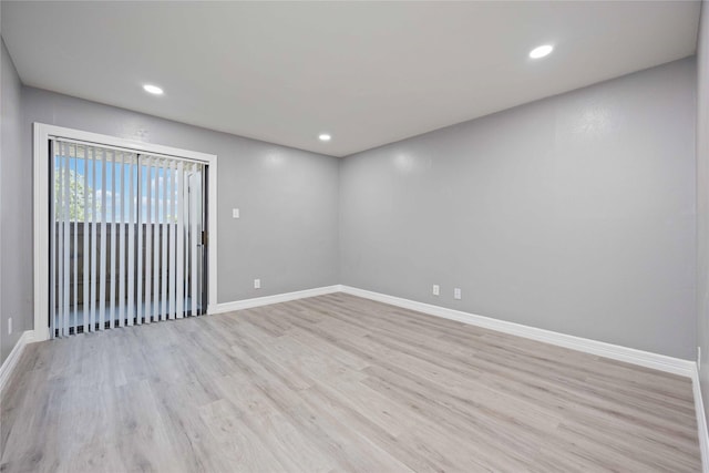 spare room with light hardwood / wood-style flooring