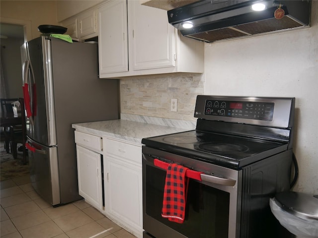 kitchen with light tile patterned floors, white cabinetry, backsplash, stainless steel appliances, and ventilation hood