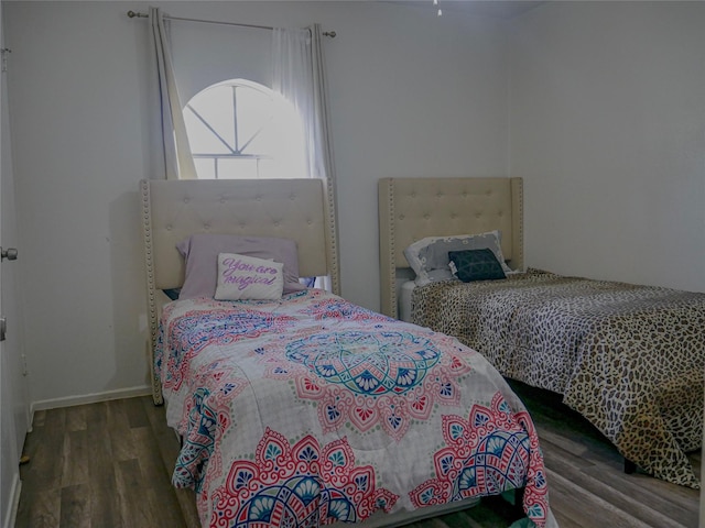 bedroom with dark wood-type flooring