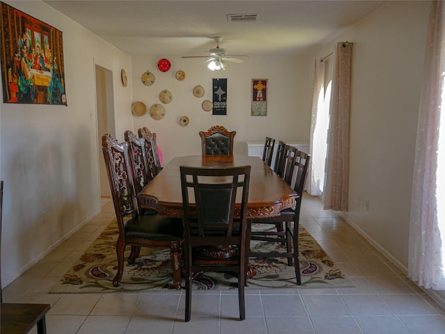 tiled dining area featuring ceiling fan