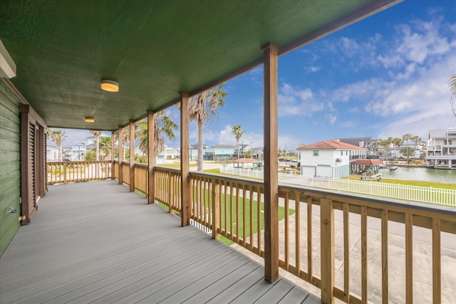 wooden terrace featuring a water view and a residential view