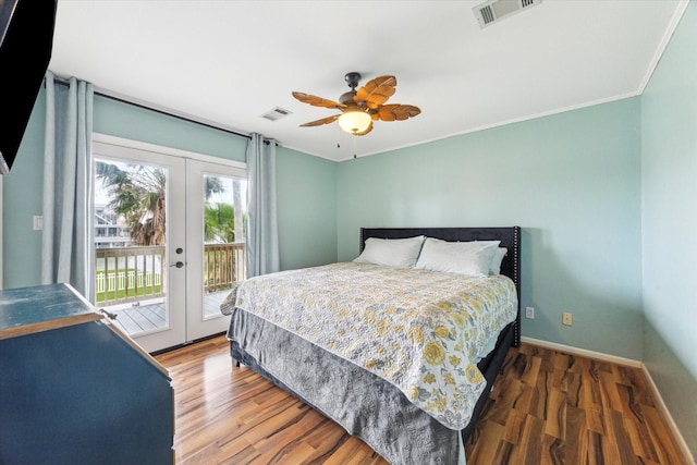 bedroom with baseboards, visible vents, wood finished floors, access to outside, and french doors