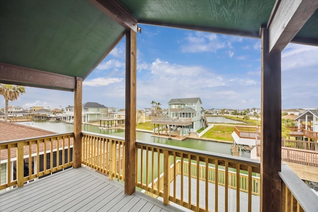 wooden deck featuring a residential view and a water view