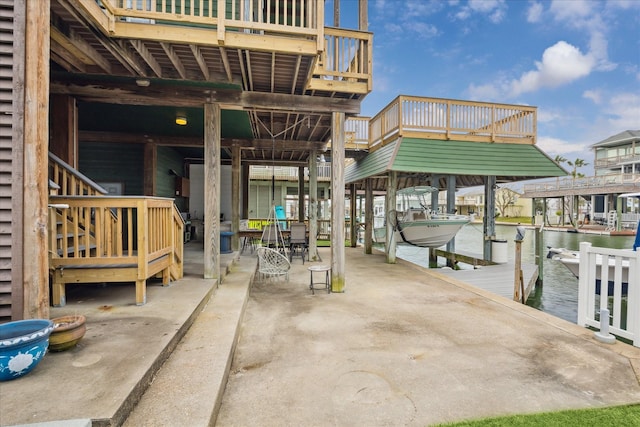 view of patio / terrace featuring a boat dock, a water view, and boat lift