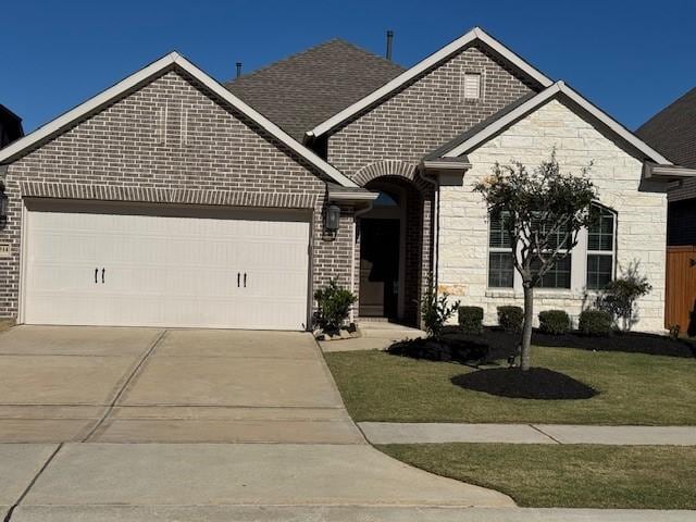 view of front of property with a garage and a front yard