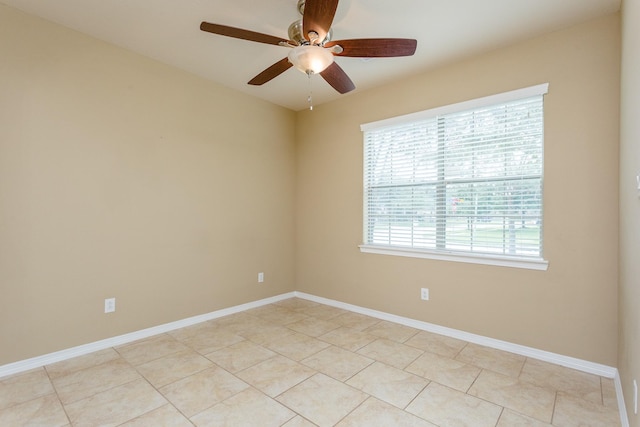 spare room featuring light tile patterned floors and ceiling fan