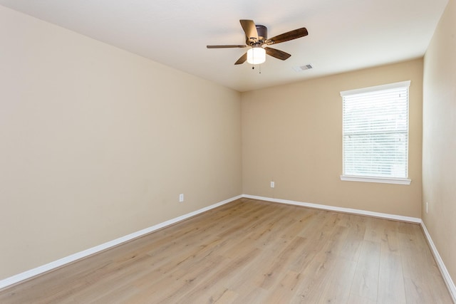 empty room with ceiling fan and light wood-type flooring