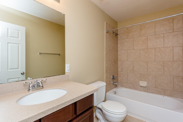 full bathroom with tiled shower / bath, vanity, and toilet