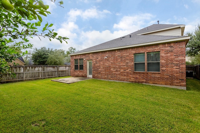 rear view of house featuring a patio and a lawn