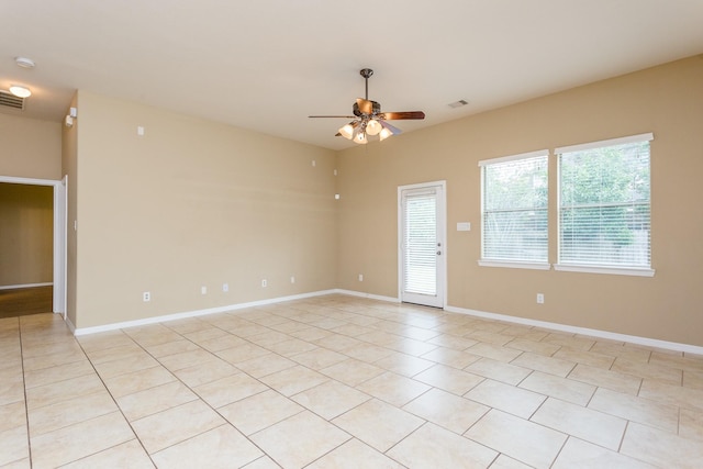 tiled spare room featuring ceiling fan