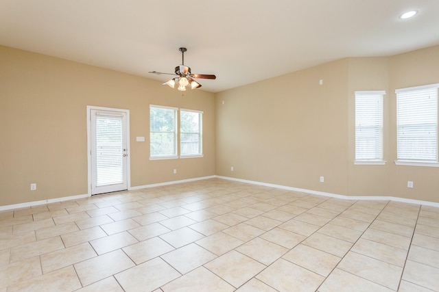 spare room featuring light tile patterned flooring and ceiling fan