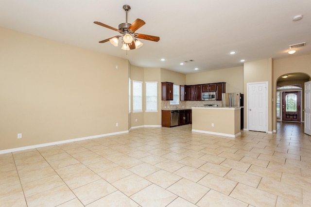 unfurnished living room with ceiling fan and light tile patterned floors