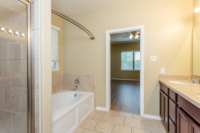 bathroom with tile patterned flooring, vanity, and a bathing tub