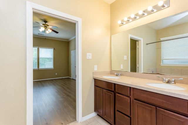 bathroom with vanity, ornamental molding, hardwood / wood-style floors, and ceiling fan