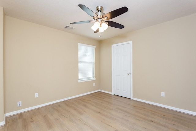 empty room with ceiling fan and light hardwood / wood-style floors