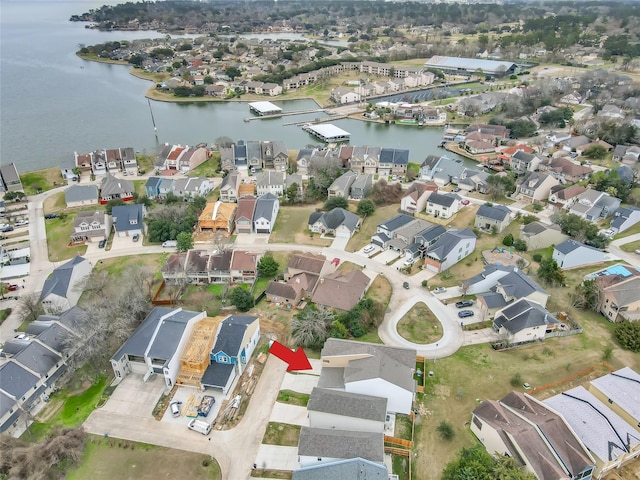 birds eye view of property with a residential view and a water view