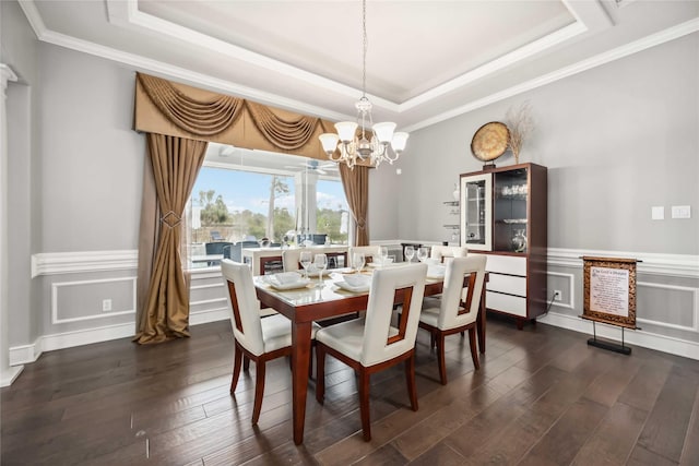 dining space with crown molding, dark hardwood / wood-style flooring, and a tray ceiling