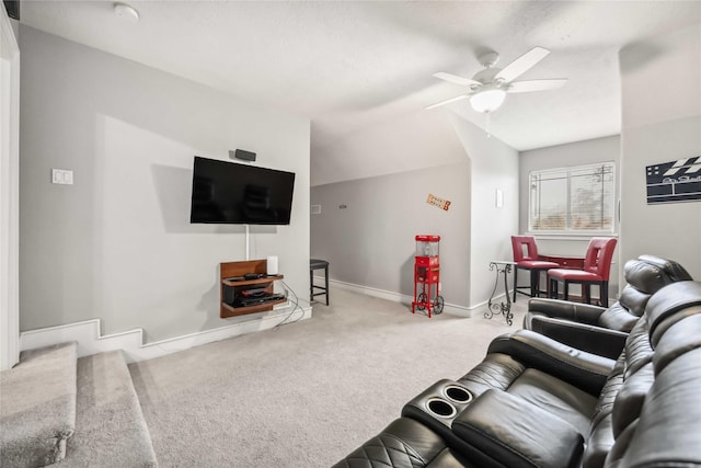 living room featuring ceiling fan, lofted ceiling, and carpet floors