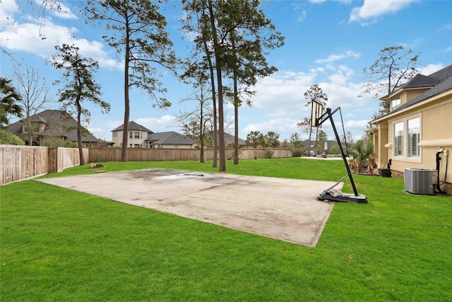 view of yard with central AC and a patio area