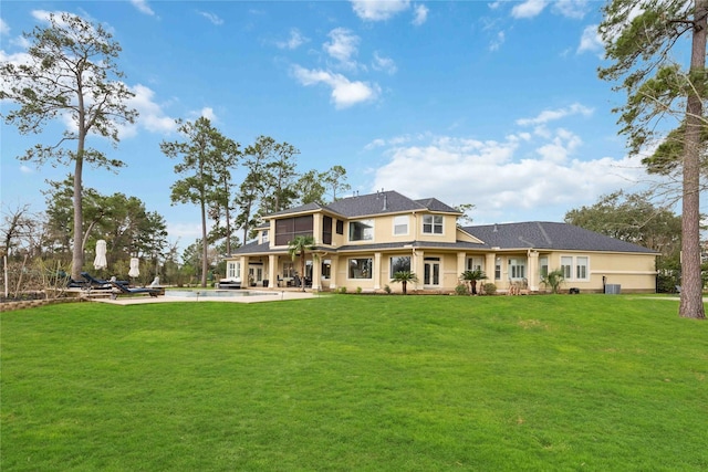 rear view of property with a patio area and a lawn