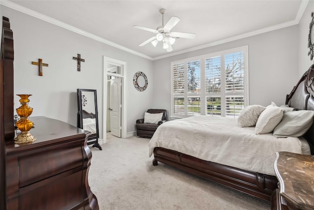 carpeted bedroom featuring crown molding and ceiling fan