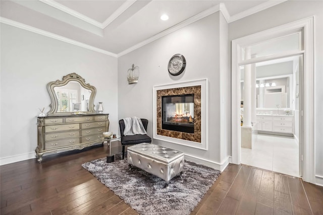 living area featuring dark wood-type flooring, a high end fireplace, and ornamental molding