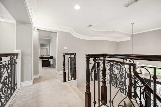 hall with crown molding, light colored carpet, and a notable chandelier