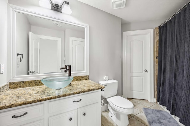 bathroom featuring vanity, toilet, and tile patterned flooring